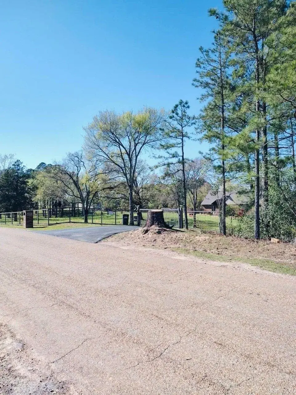 Stump removal at a gated property entrance in Hot Springs, AR